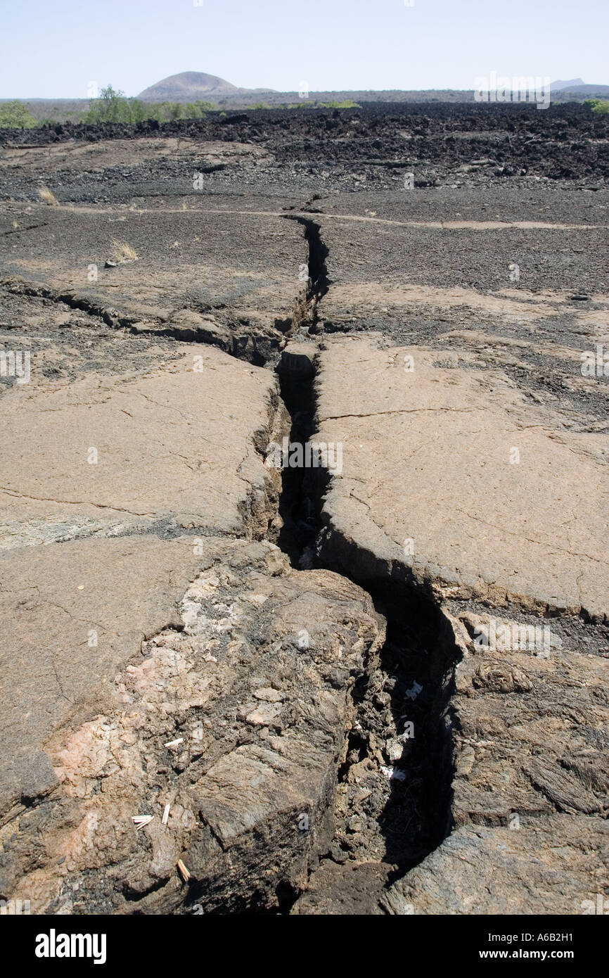 Major crack in Shitani lava flow with volcanic cones of Chyulu Hills Tsavo National Park West Kenya East Africa Stock Photo