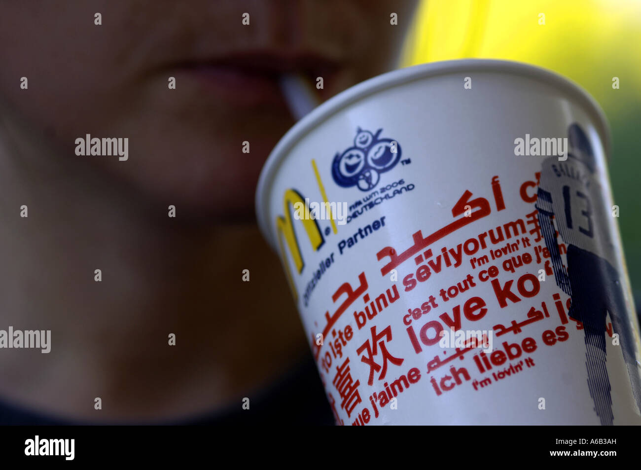 woman drink drinking macdonalds mcdonalds mouth straw fastfood cup red love  languages global international female face close up Stock Photo - Alamy