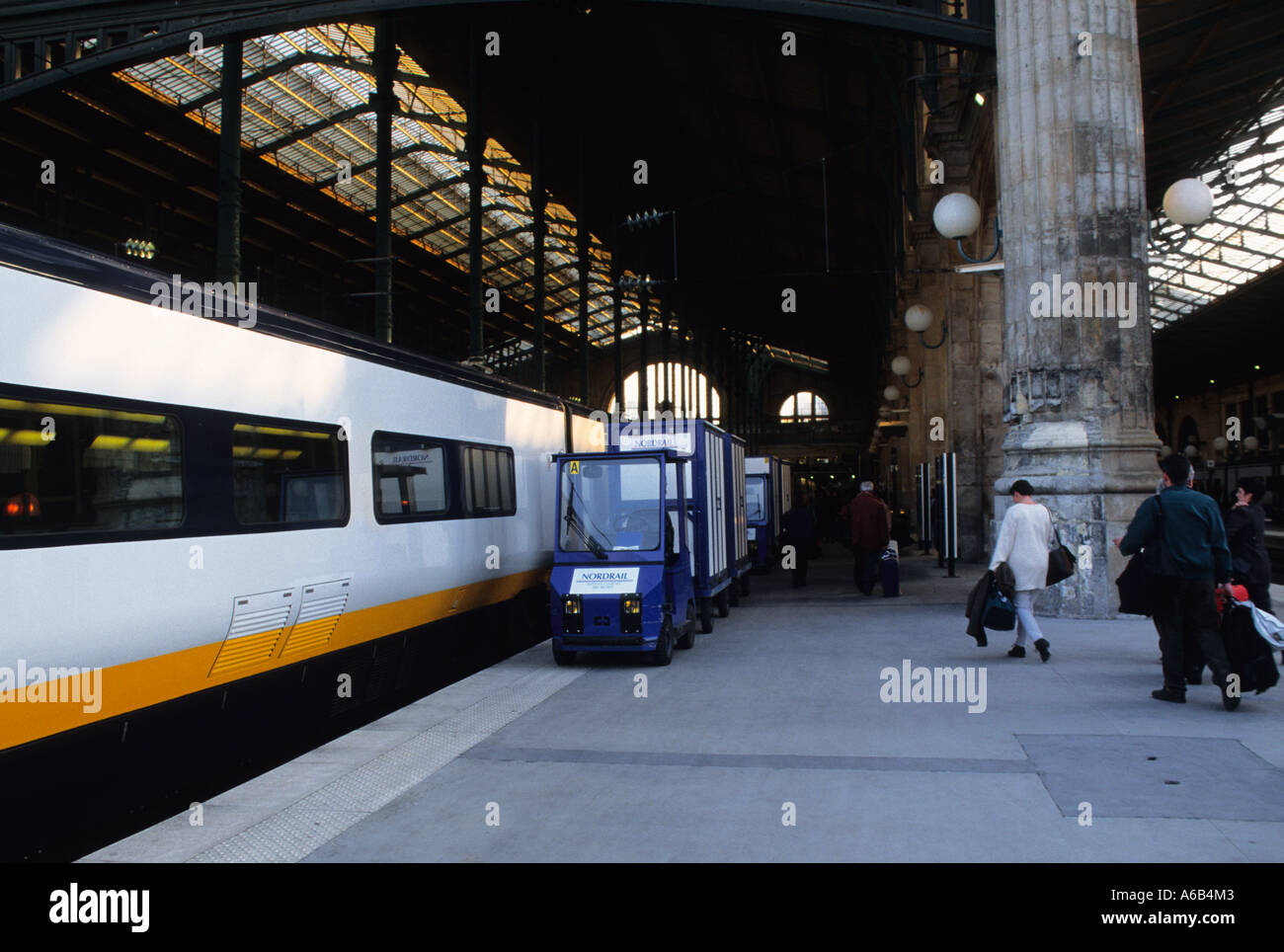 Paris Gare du Nord Eurostar railroad station platform passengers with their luggage rushing to
