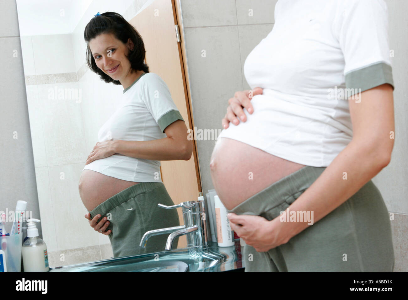 Pregnant woman in bathroom Stock Photo
