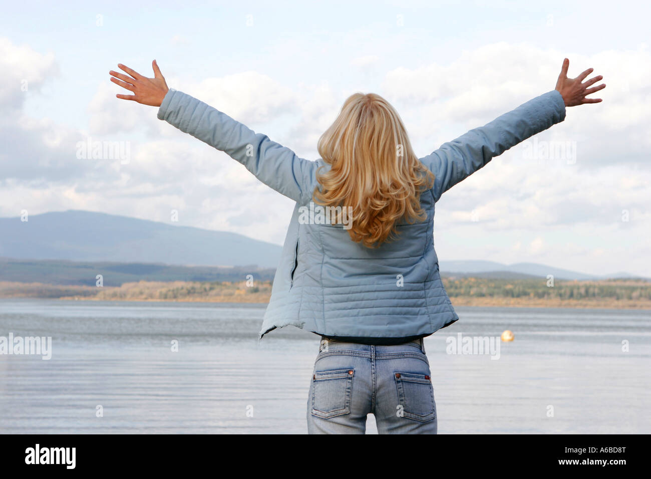 Happy young woman on lake Stock Photo