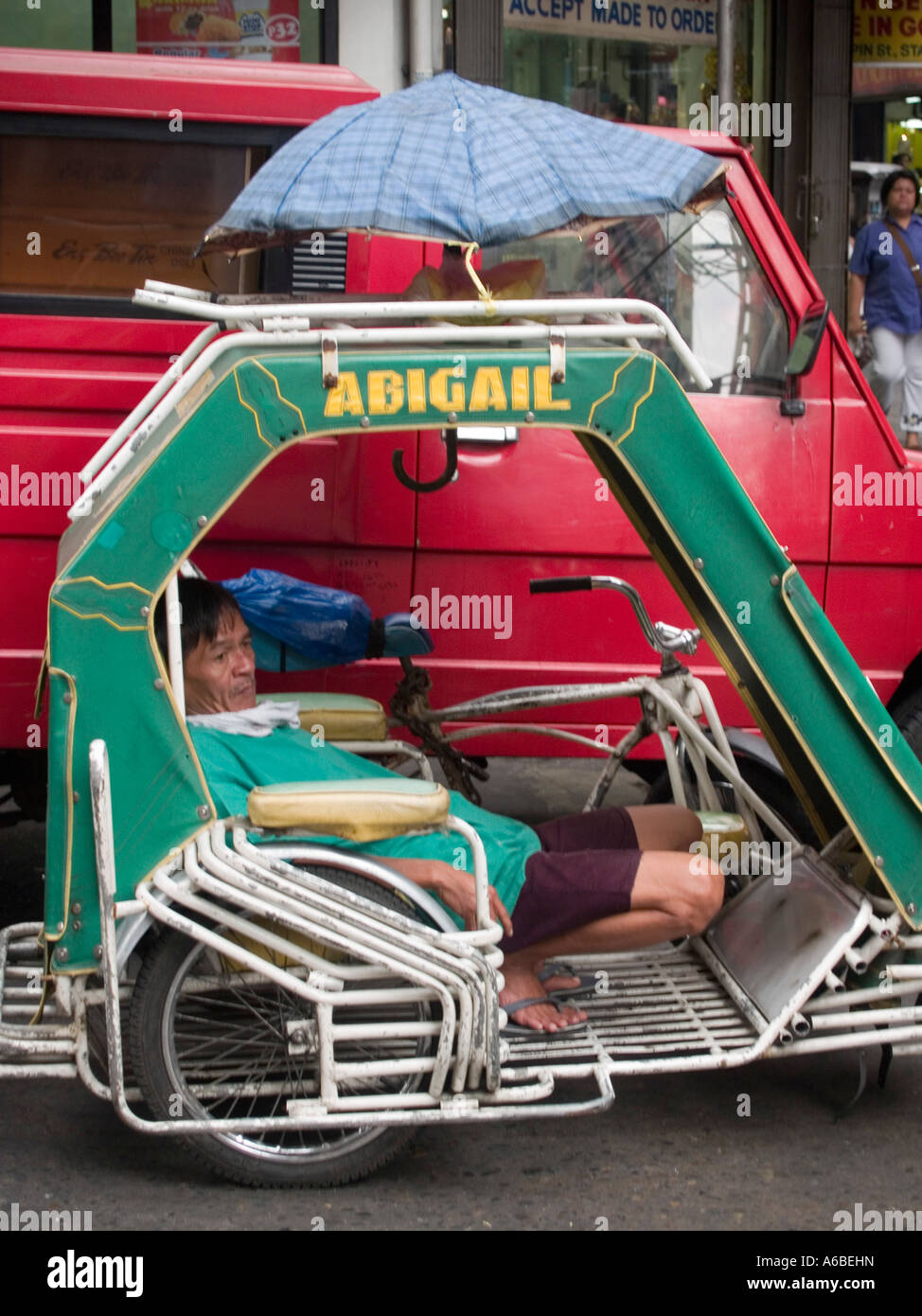 a tricycle driver at rest Manila Philippines Stock Photo Alamy