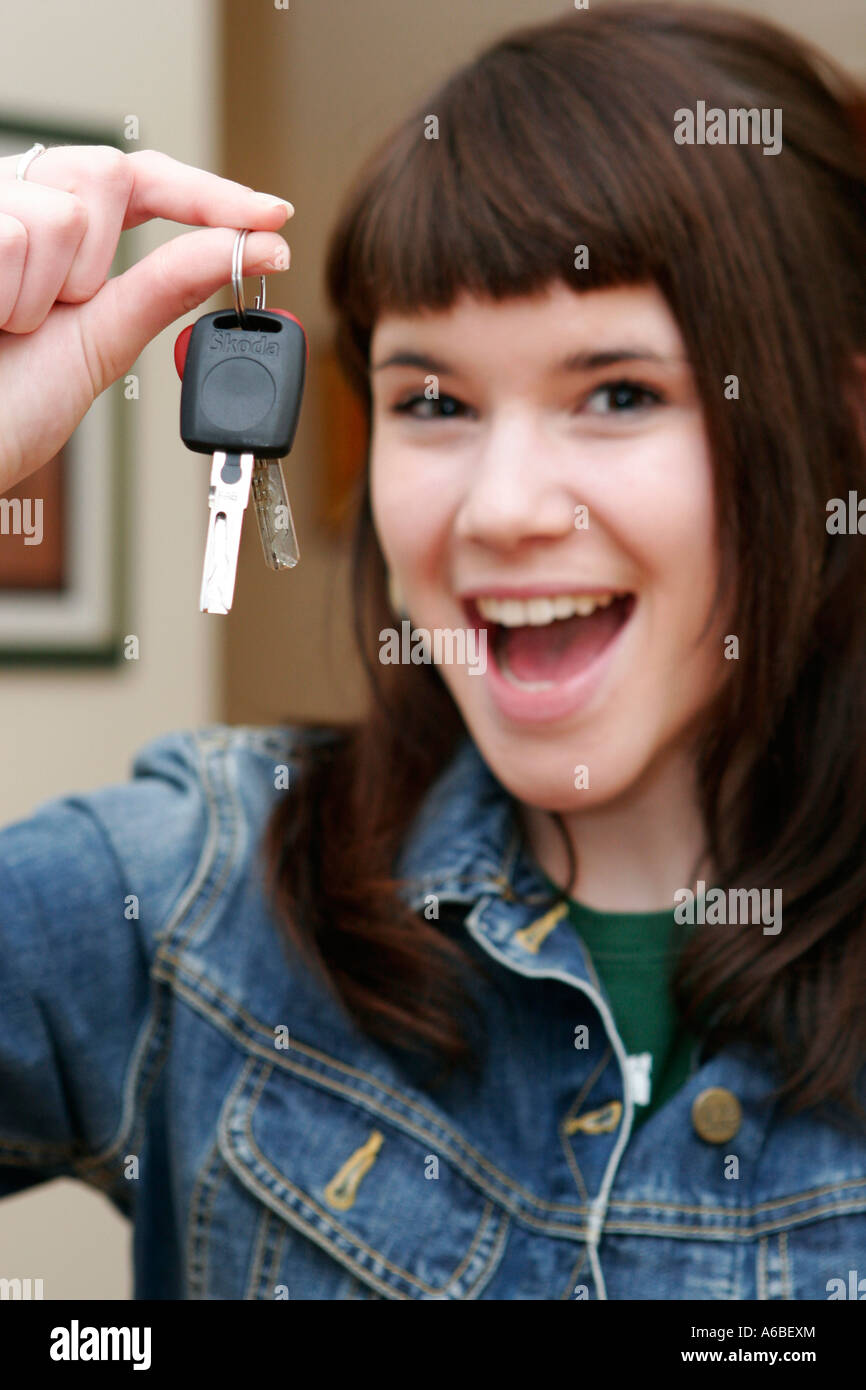 Teenage girl holding out the keys to her car Stock Photo