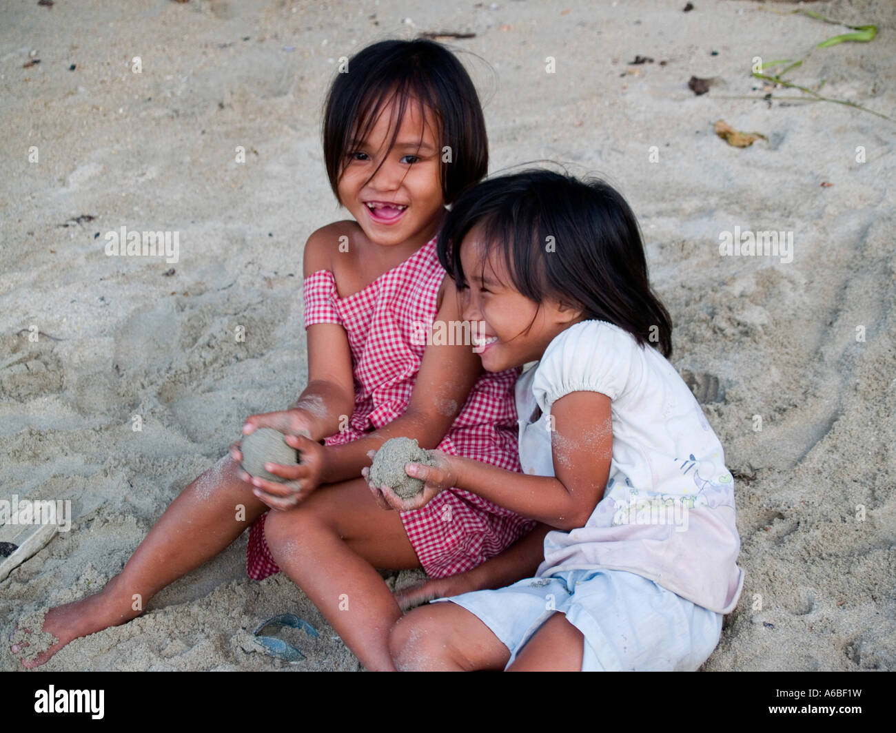 beach play 2 giggling girls on the beach in El Nido Palawan Philippines ...