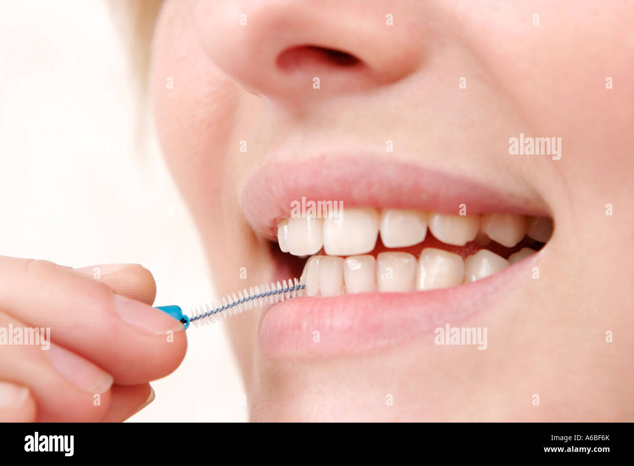 woman cleaning teeth with interdental brush Stock Photo Alamy