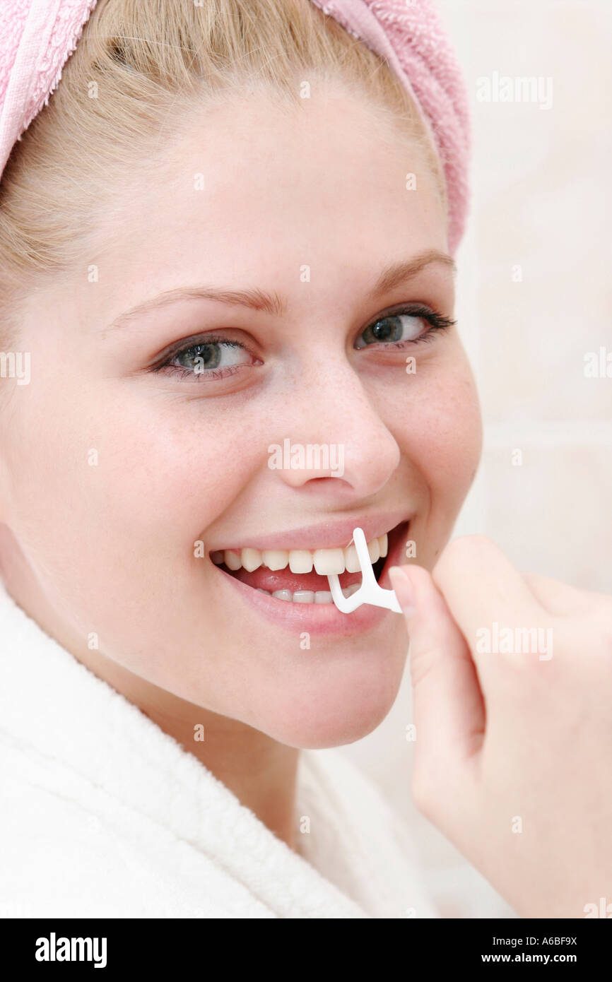 woman cleaning teeth with dental floss Stock Photo
