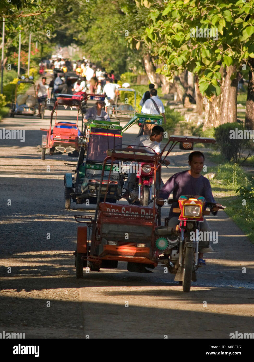 Filipino tricycle drivers on the way to work Negros Philippines Stock