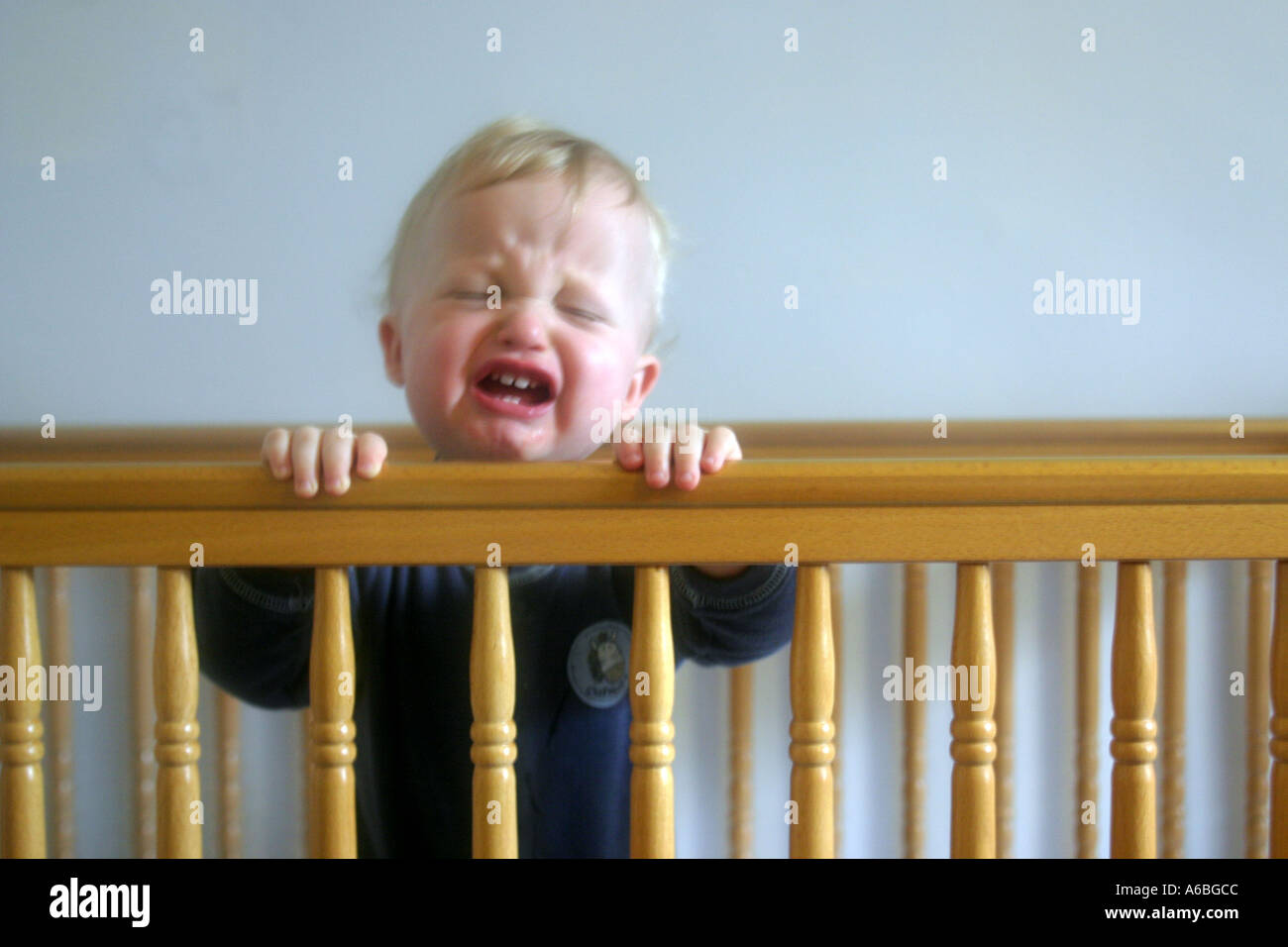 Crying Baby in Cot Stock Photo Alamy