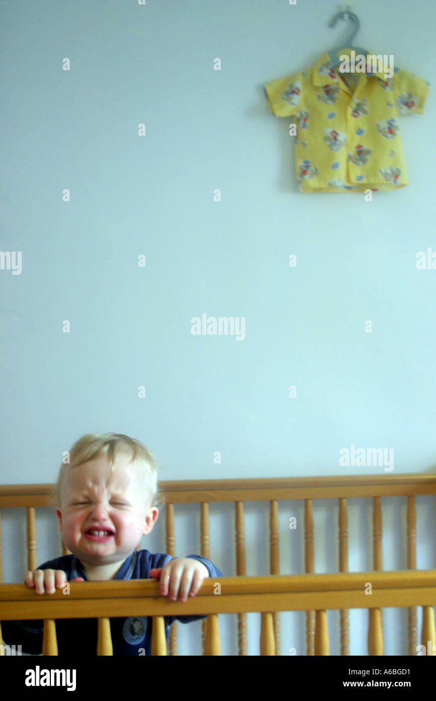 Crying Baby in Cot Stock Photo Alamy