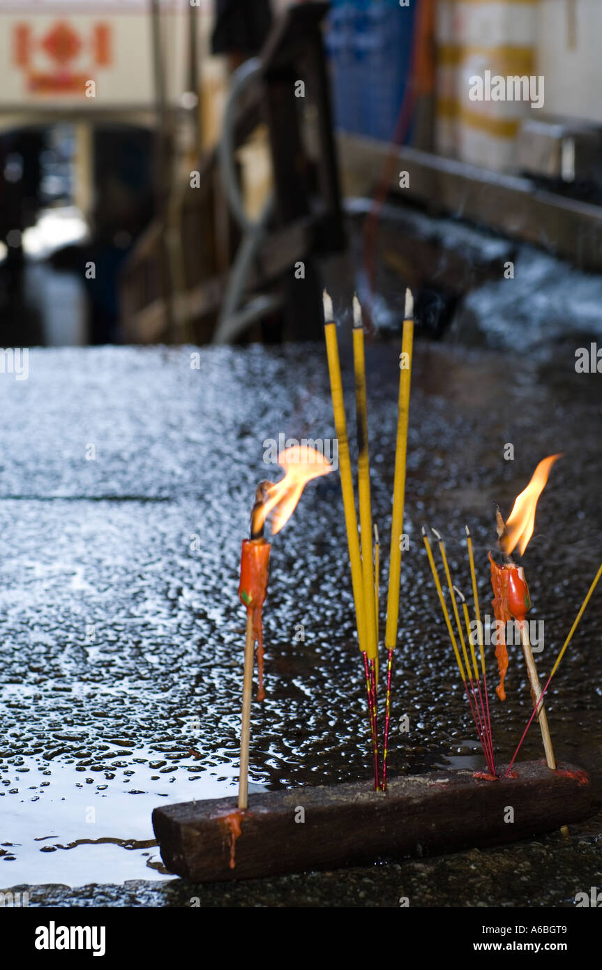 Incense and candles burn during the chineses luna new year Stock Photo