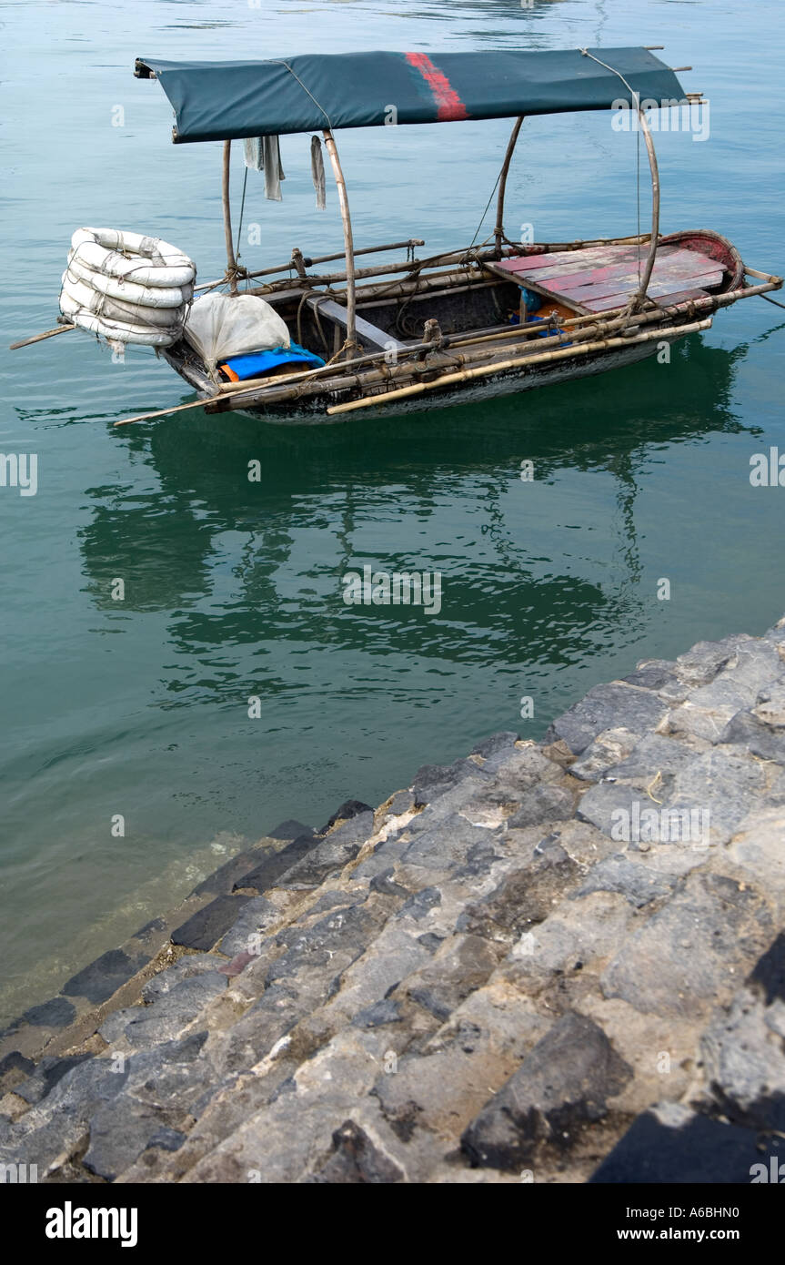 A small boat moored up in the bay Cat Ba Island North Vietnam Stock Photo