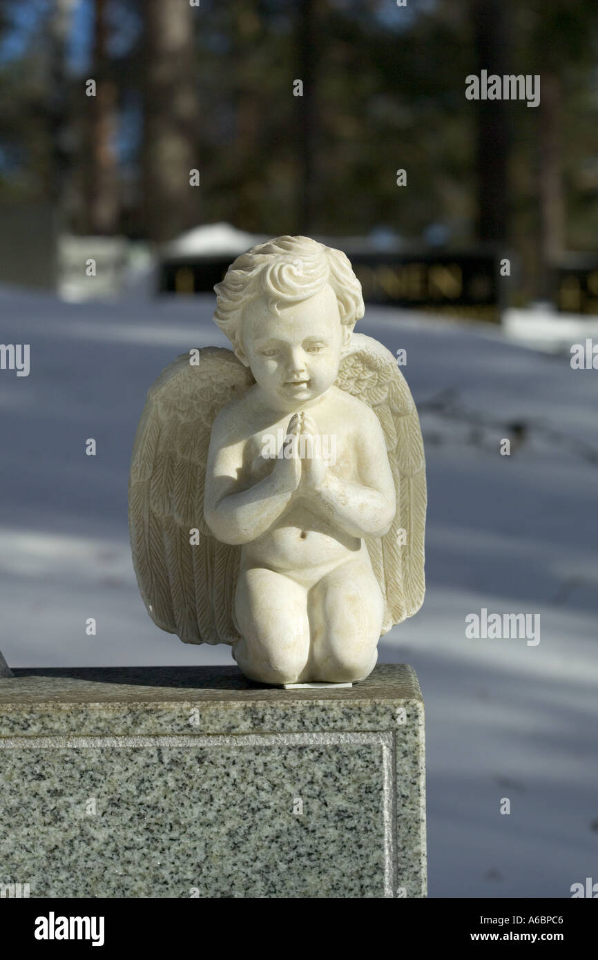 small angel statue on a grave Stock Photo Alamy