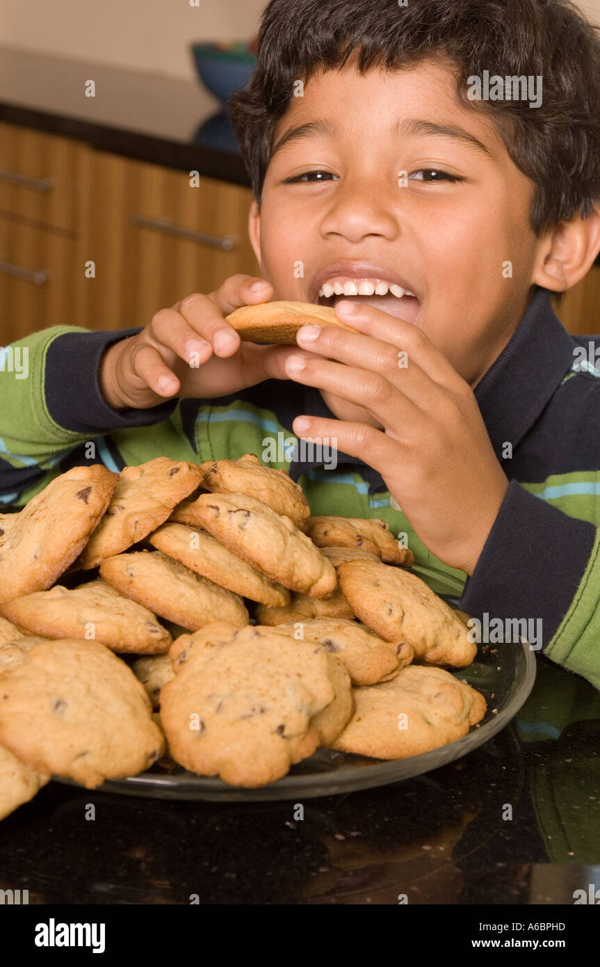 Portrait of Hispanic boy eating cookies Stock Photo