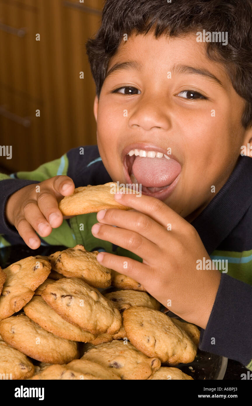 Portrait of Hispanic boy eating cookies Stock Photo