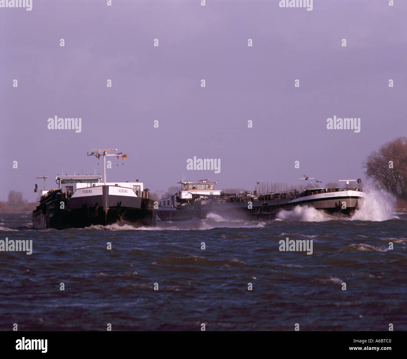 Two barges in storm on River Waal Stock Photo