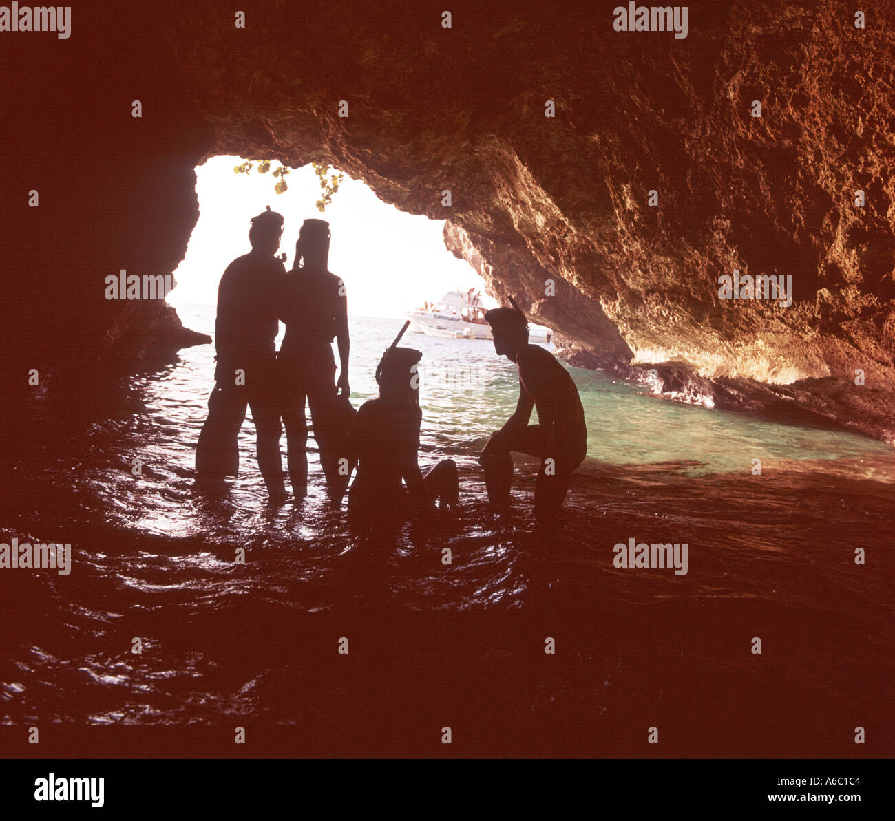 four skin divers explore cave on Caribbean island Stock Photo Alamy
