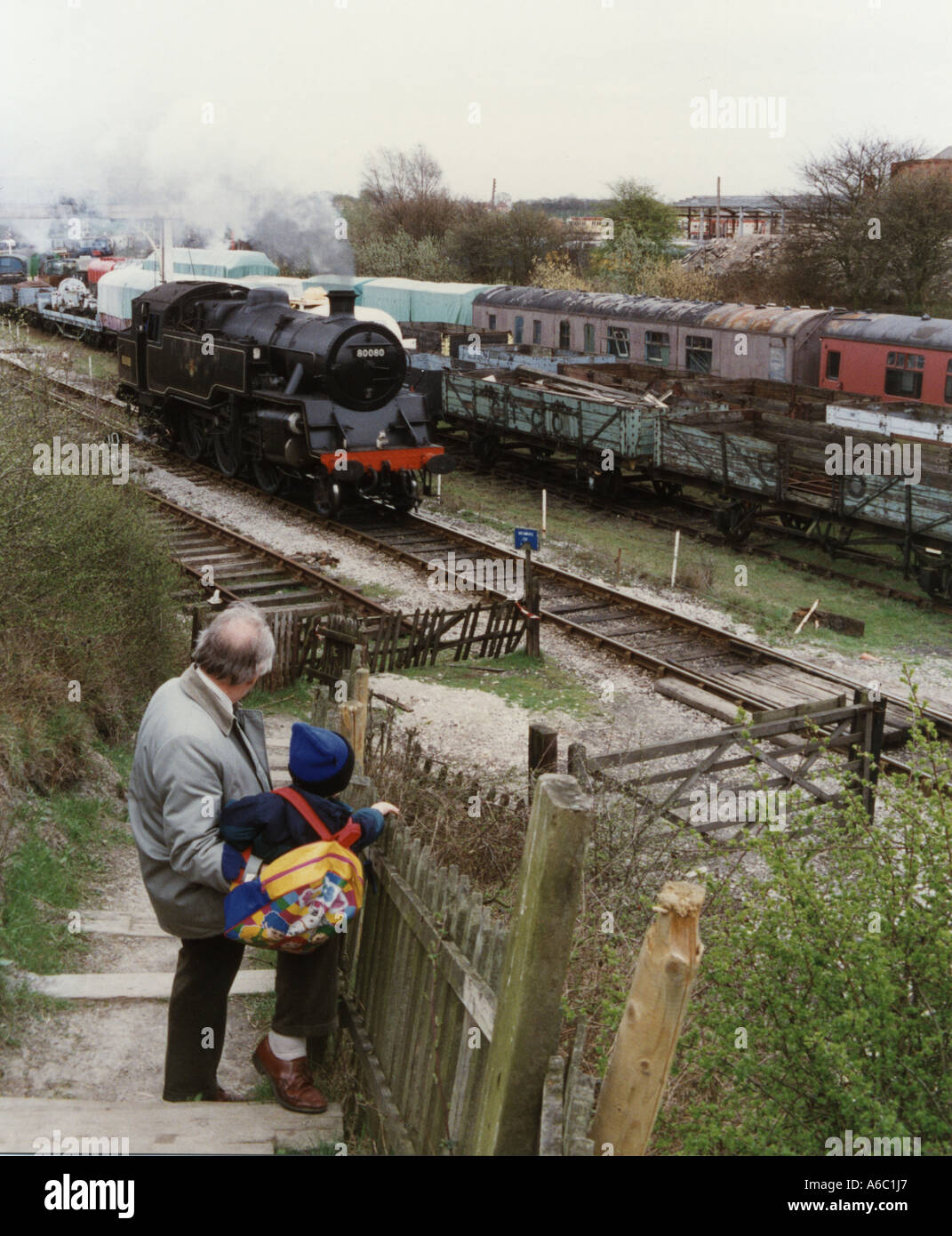 Generation gap Grandad takes his grandson to see a steam train Stock ...