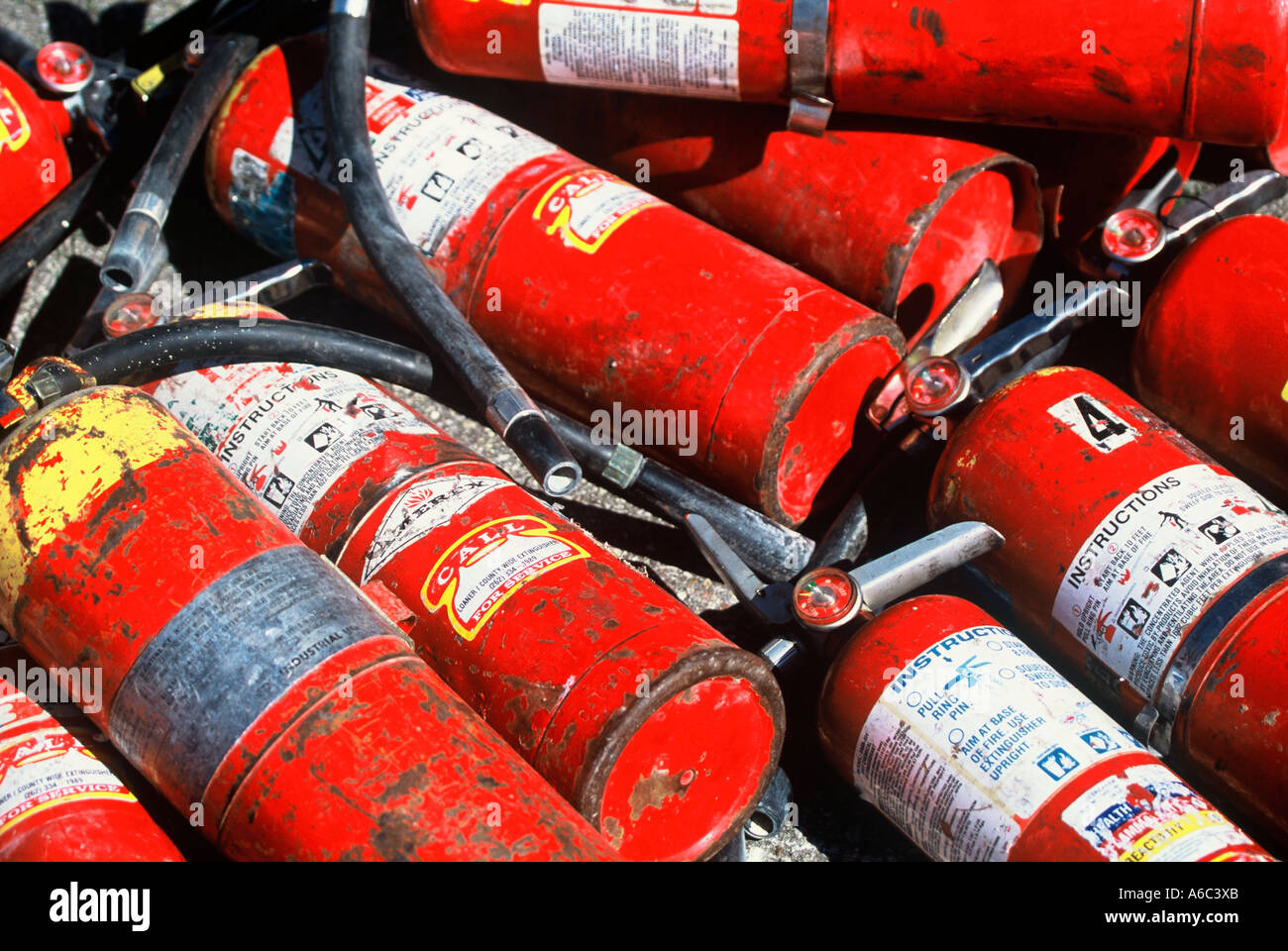 Old used extinguishers in a pile Stock Photo