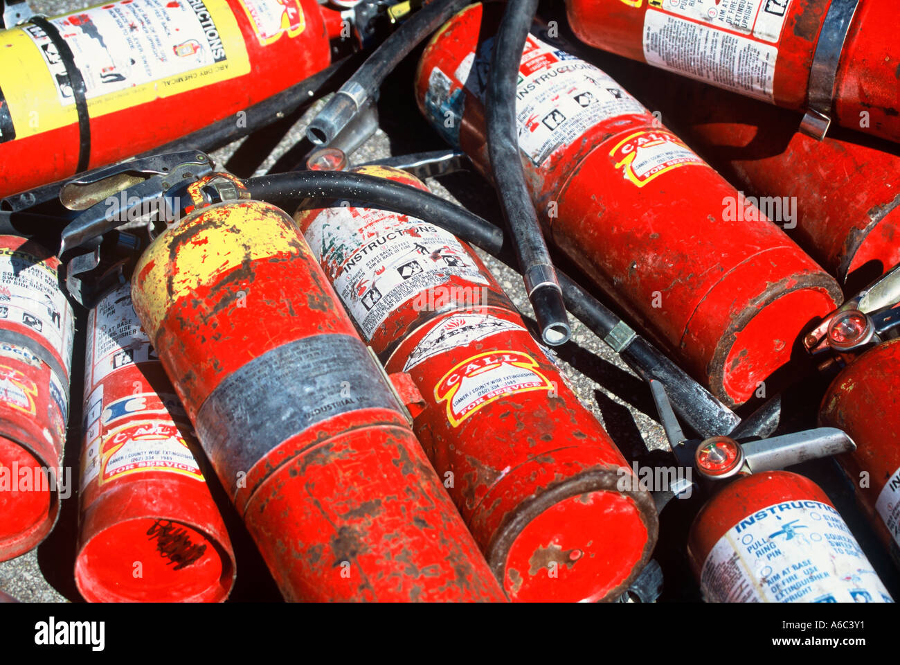 Old used extinguishers in a pile Stock Photo