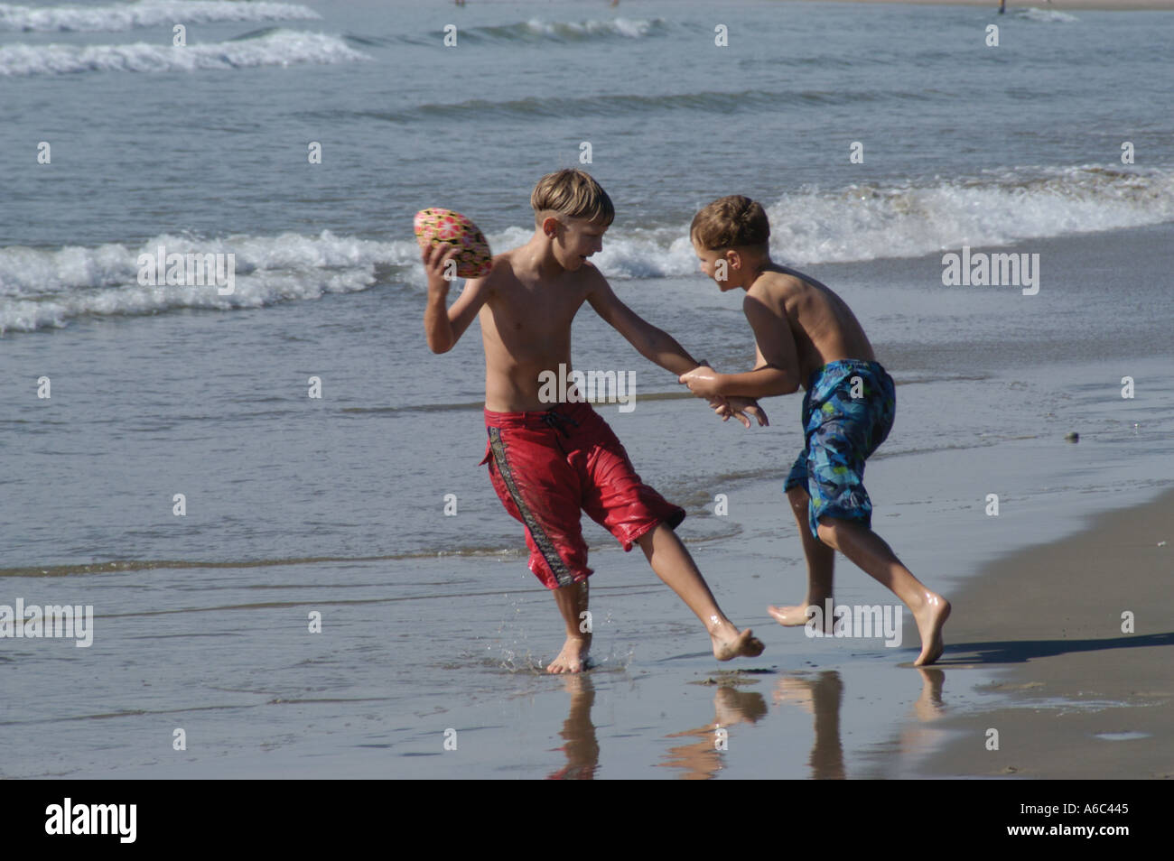 Two young boys playing in the sea Stock Photo - Alamy