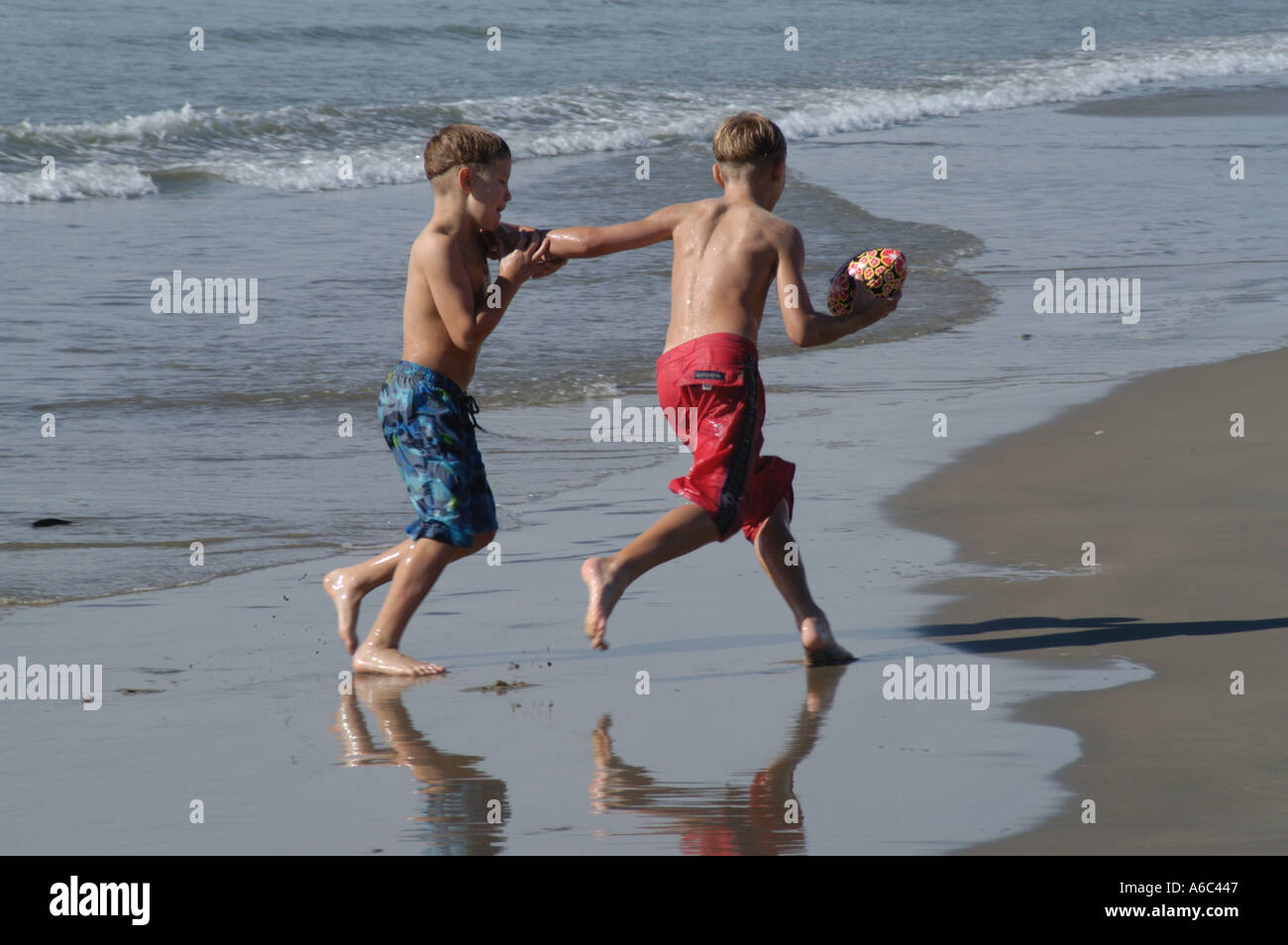 Two young boys playing in the sea Stock Photo - Alamy