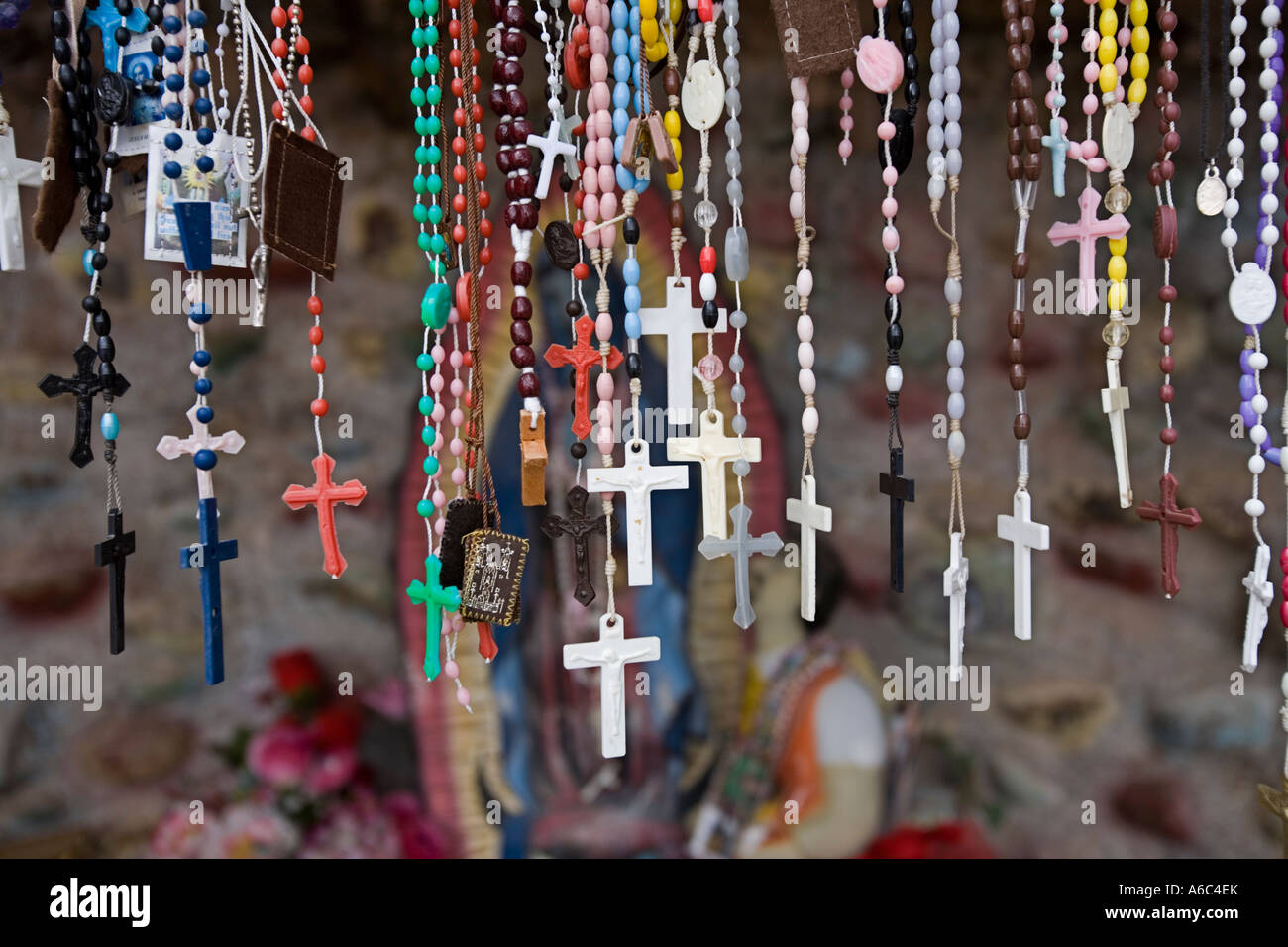 Rosaries candles and religious artifact left by believers at El Santuario de Chimayo Stock Photo