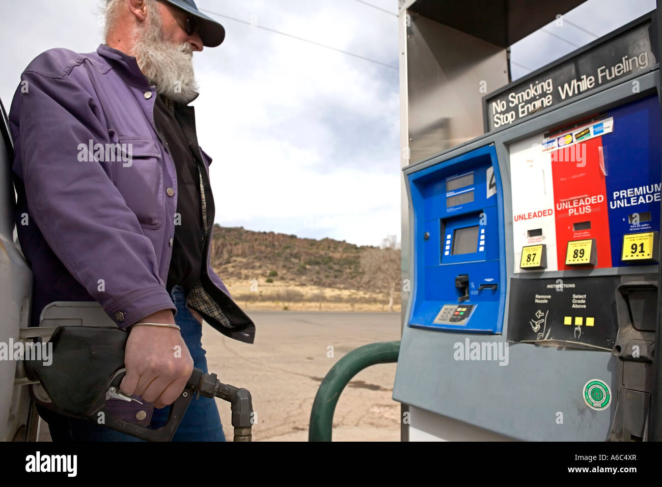 Man pumping gas at a station in West Texas Stock Photo