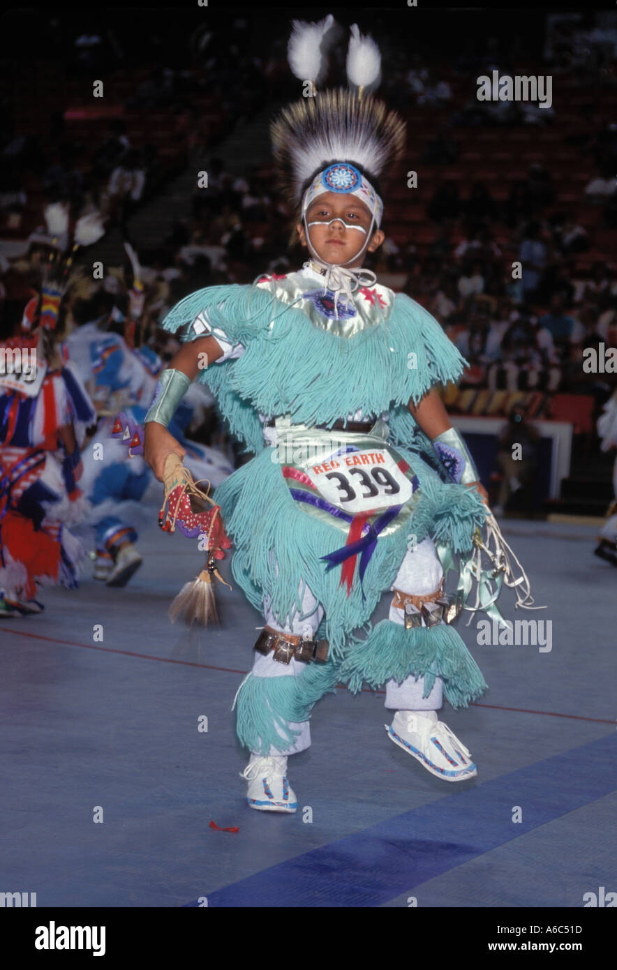 Cherokee Indian boy in costume dancing in competition at powwow Red Earth festival tribal dance Stock Photo