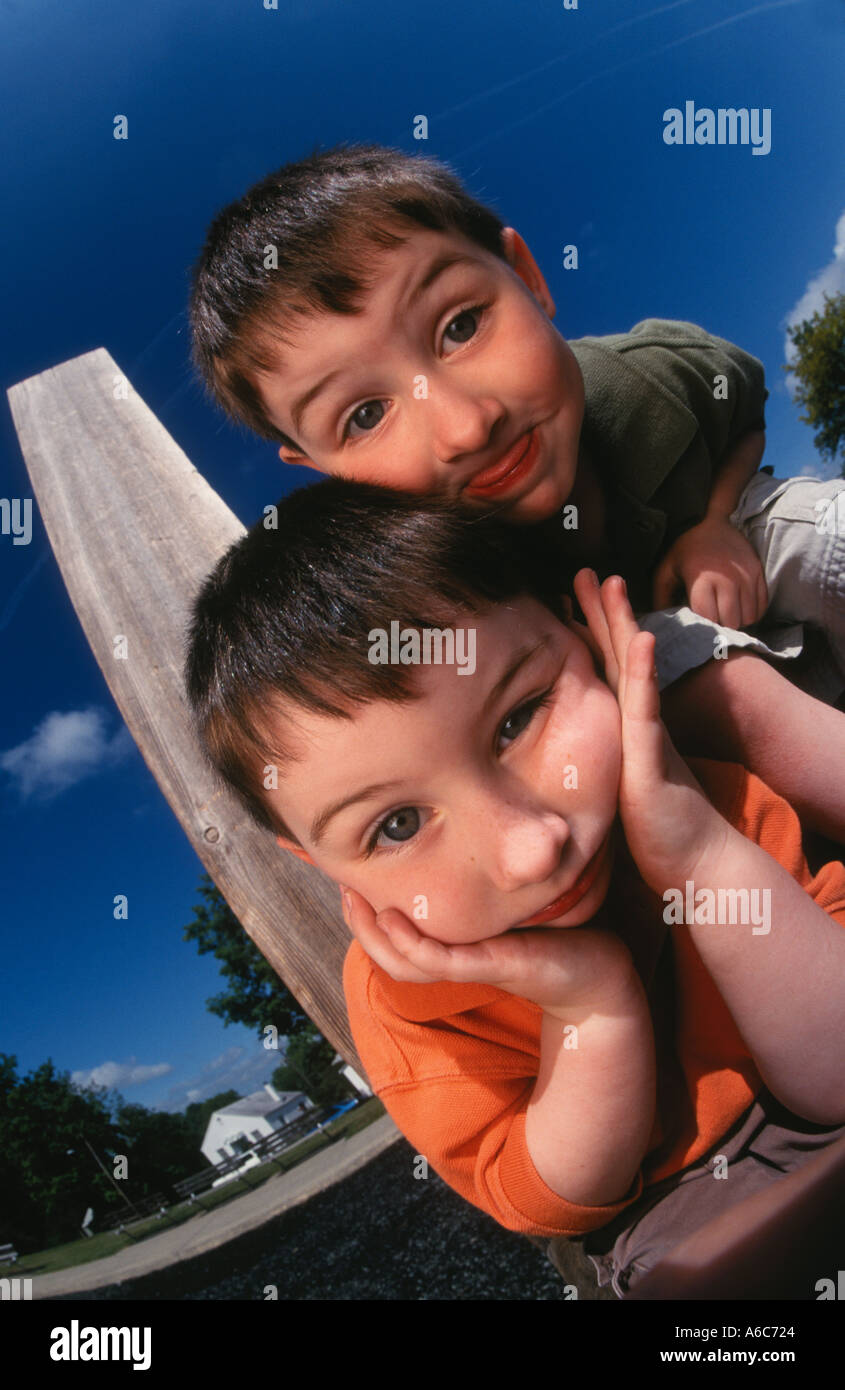 boys twin boys playing outside portrait happy together Stock Photo - Alamy