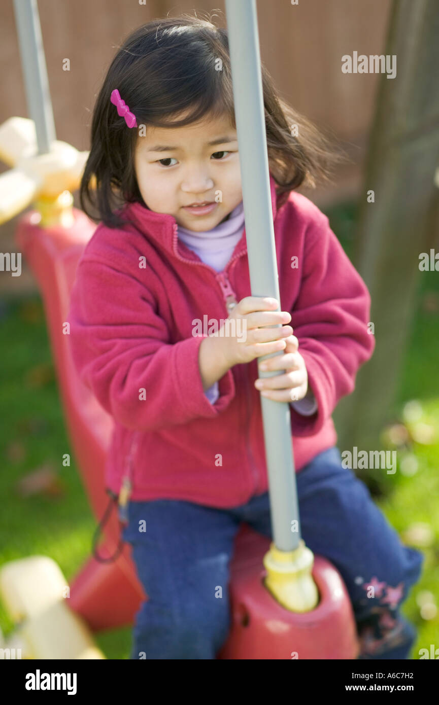 3 Year Old Japanese Girl On Backyard Swing Stock Photo