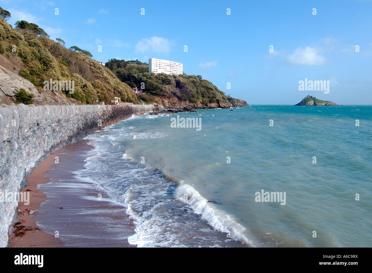 Fantastic sunny day at Meadfoot beach near Torquay with blue sky and azure sea gently breaking on the shore Stock Photo