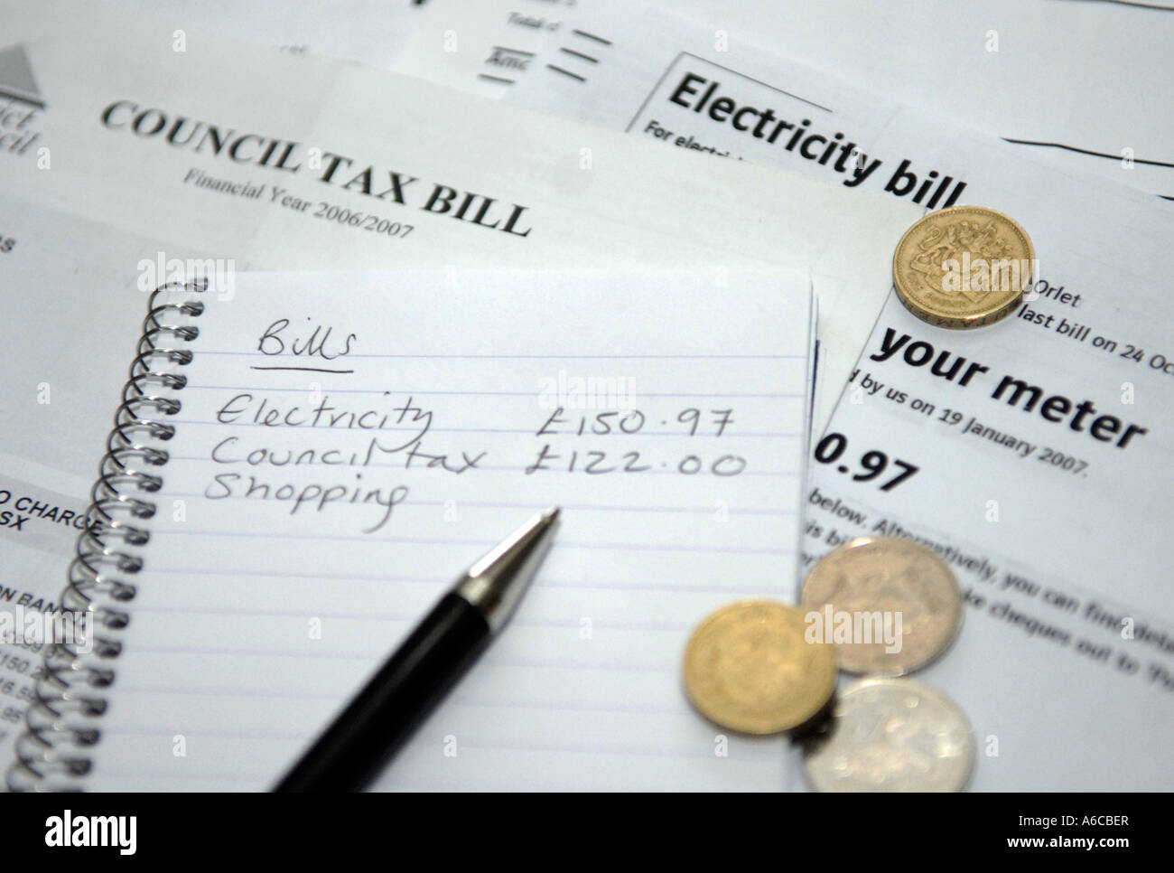 A list of household bills and money Stock Photo