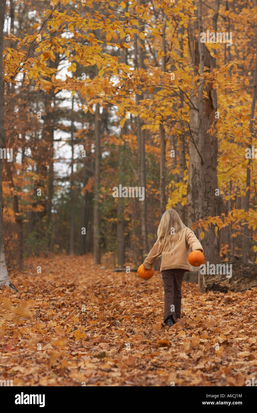 Girl Walking Through Autumn Leaves Stock Photo - Alamy