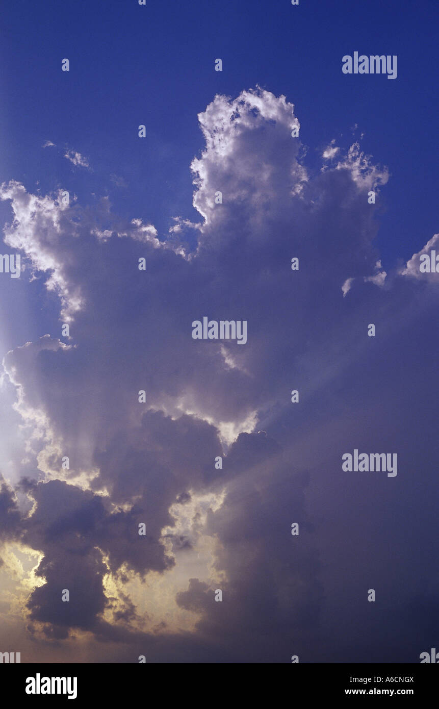Sun shining through clouds Stock Photo - Alamy