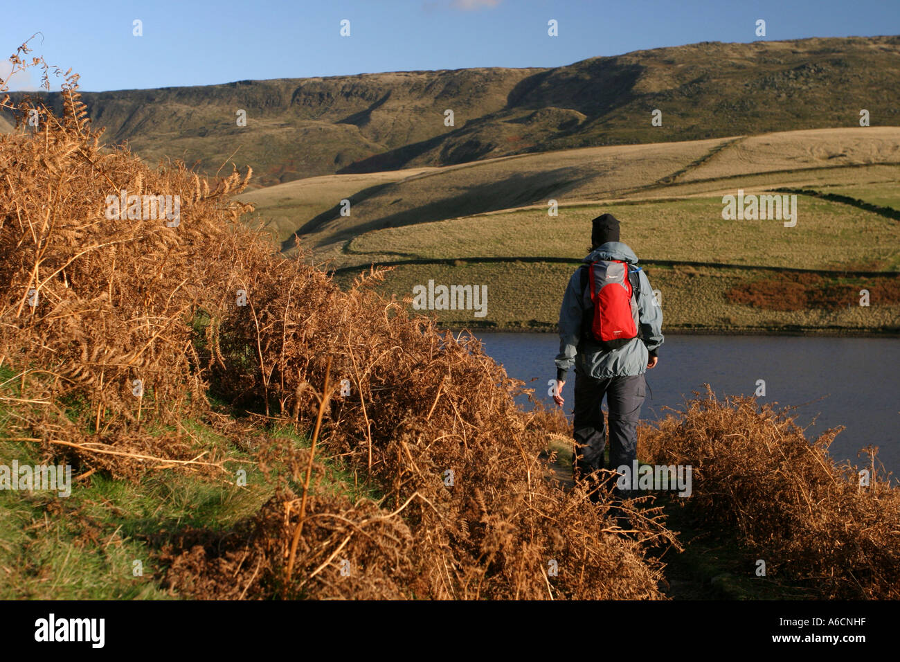 Walking by Kinder Reservoir with Kinder Scout in the background. Stock Photo