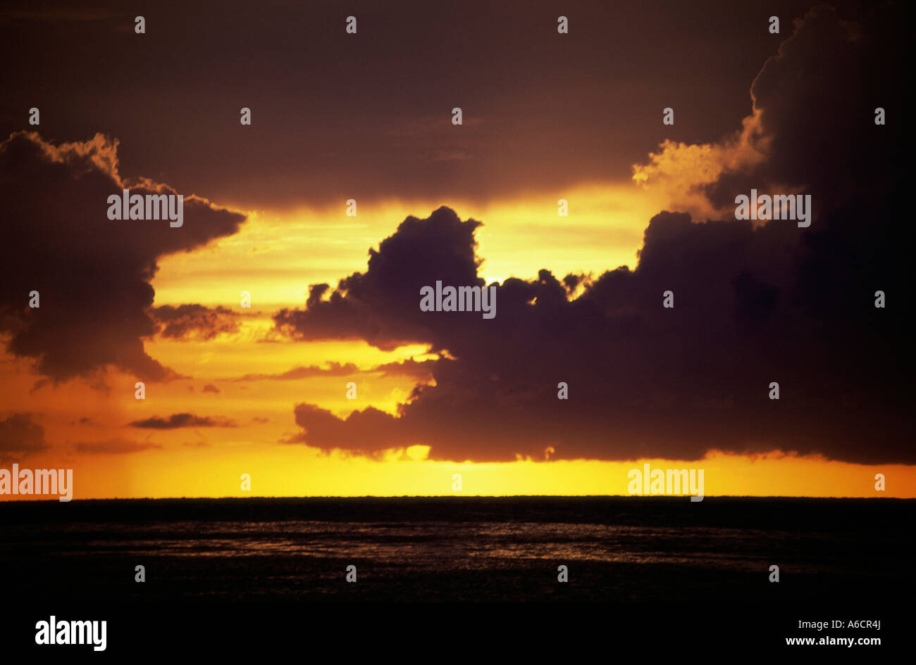 Cloudy sky over ocean sunset hi-res stock photography and images - Alamy