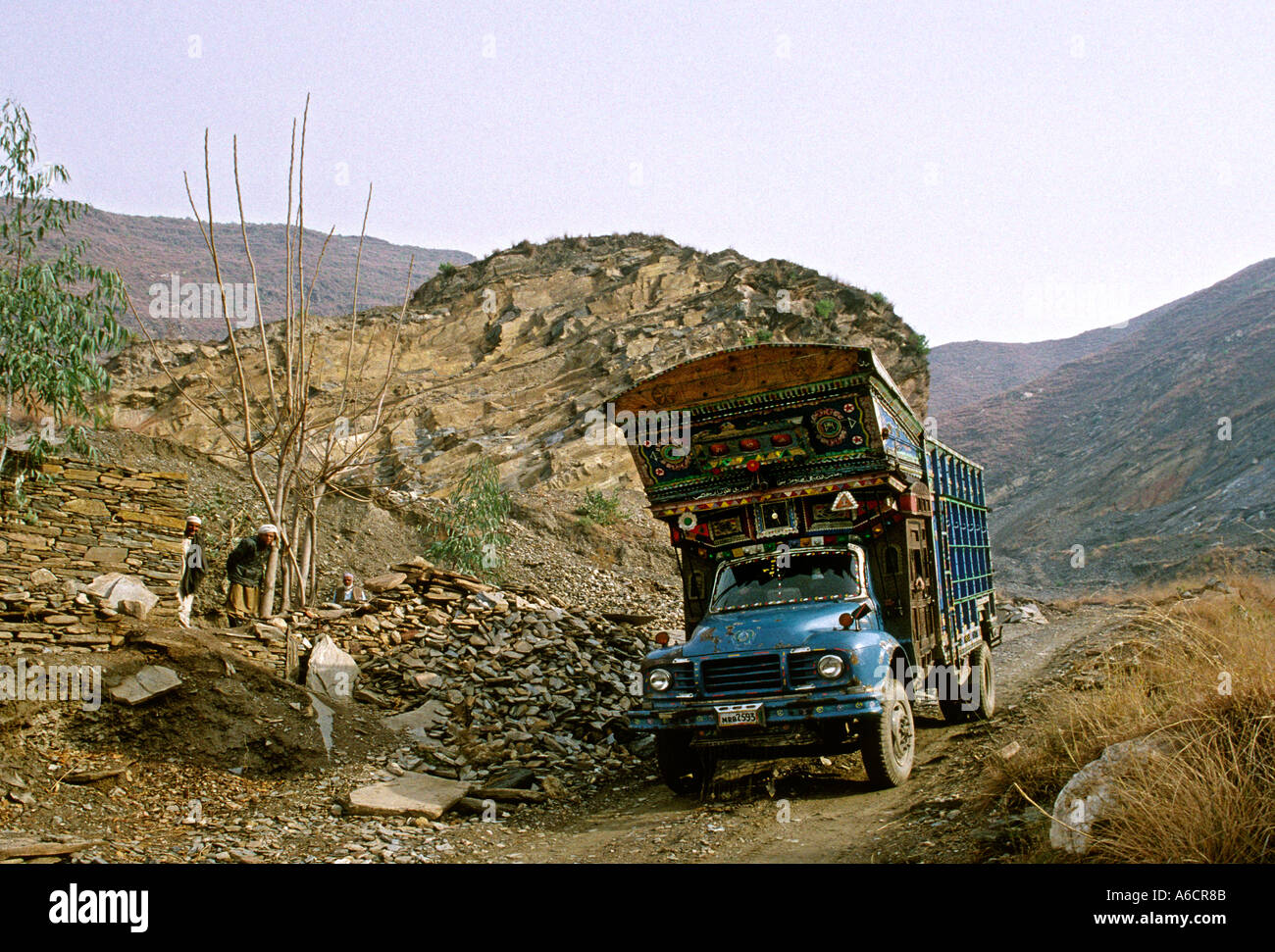 Pakistan Swat Valley decorated truck in hillside quarry near Mingora Stock Photo