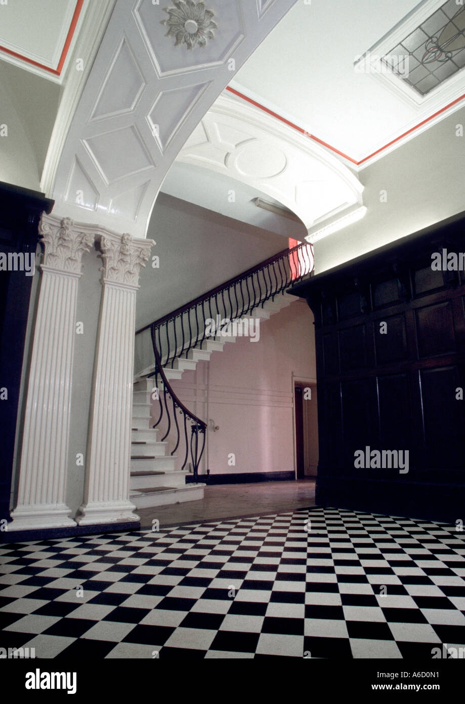 Wood panelled grand entrance hall with checkered marble floor Stock Photo