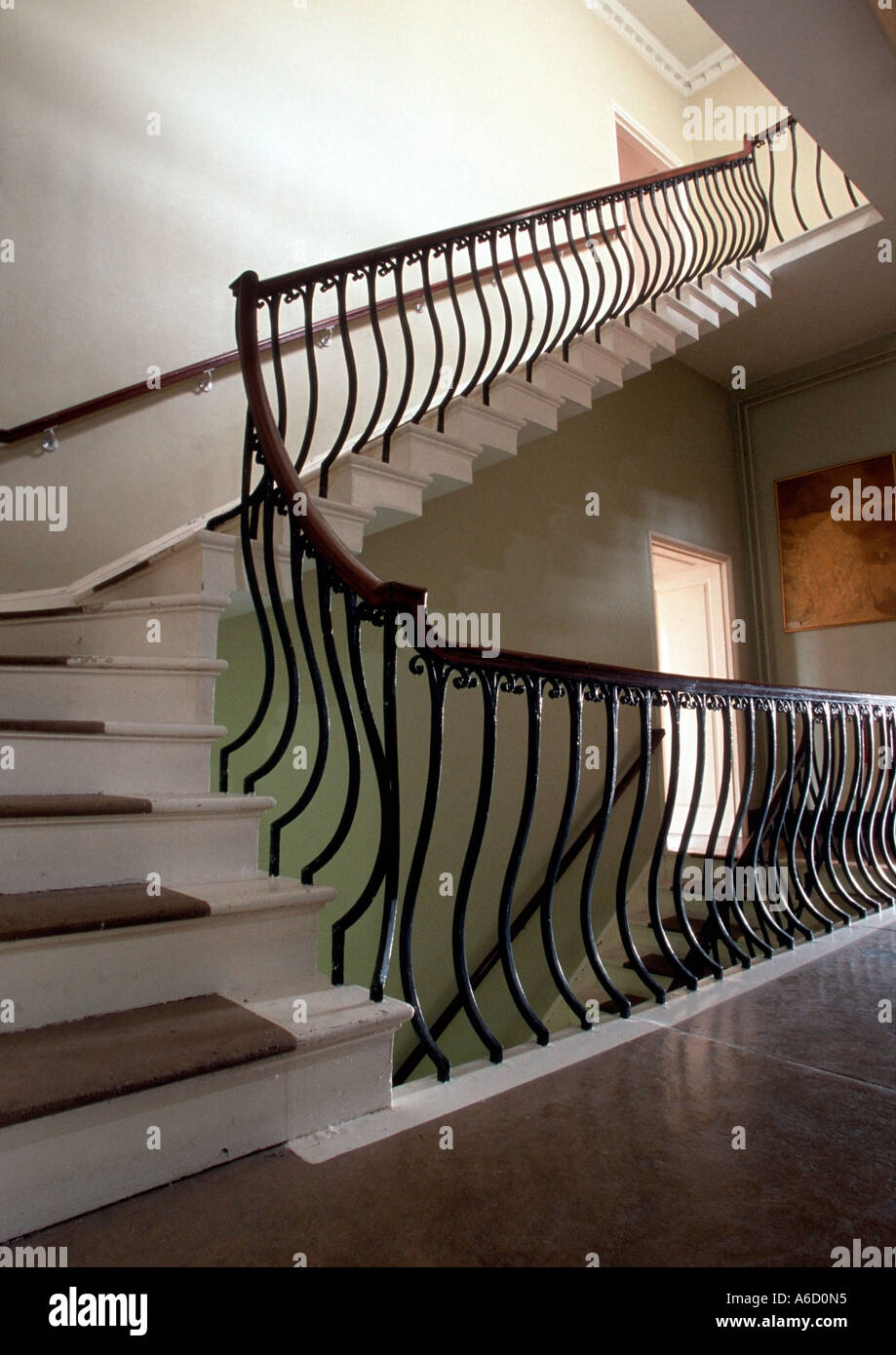 An internal staircase with an cast iron banister Stock Photo Alamy