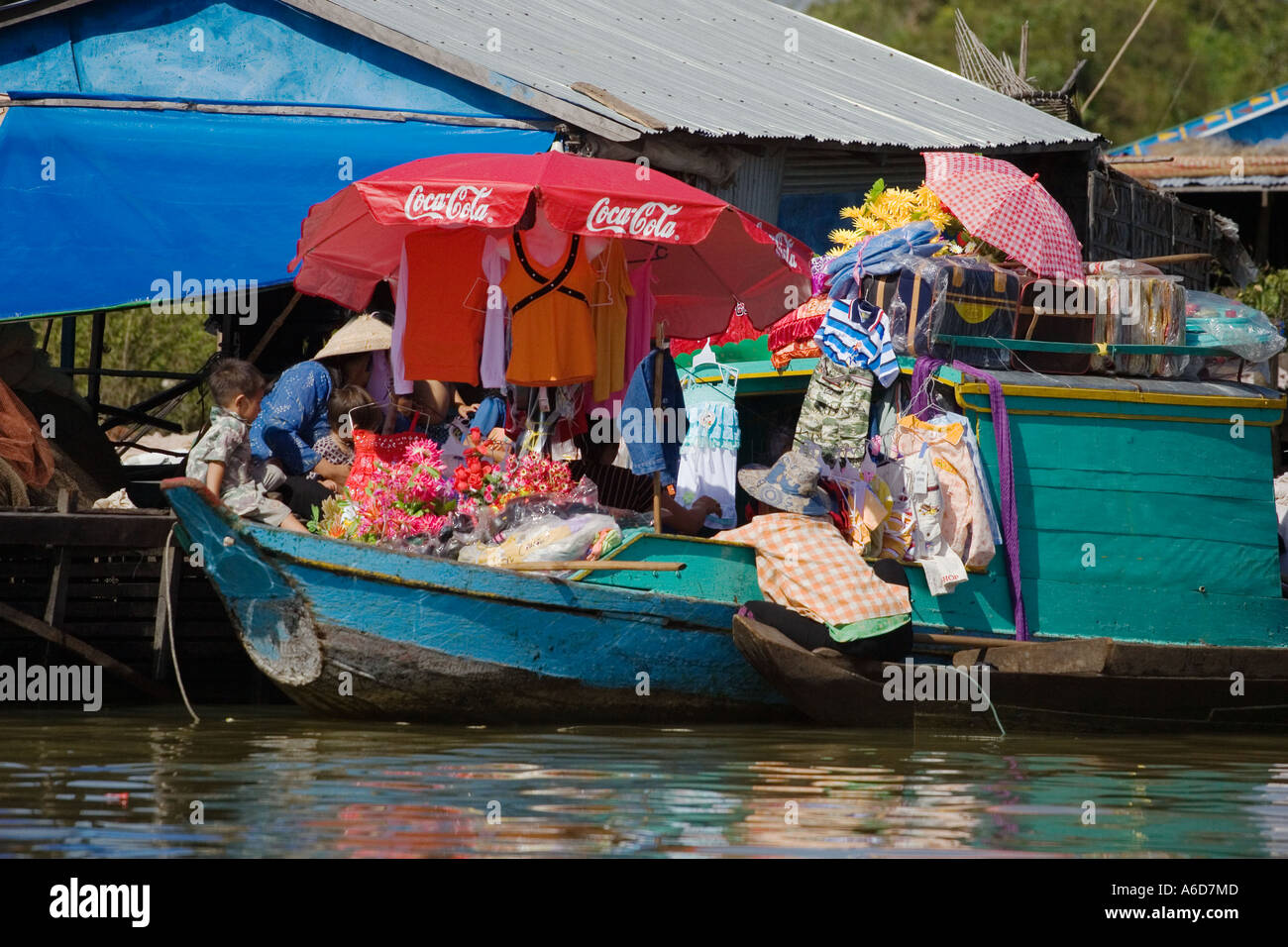 Merchant boat with Coca cola umbrella in the Vietnamese floating village of Chong Kneas lake Tonle Sap Siem Reap Cambodia Stock Photo