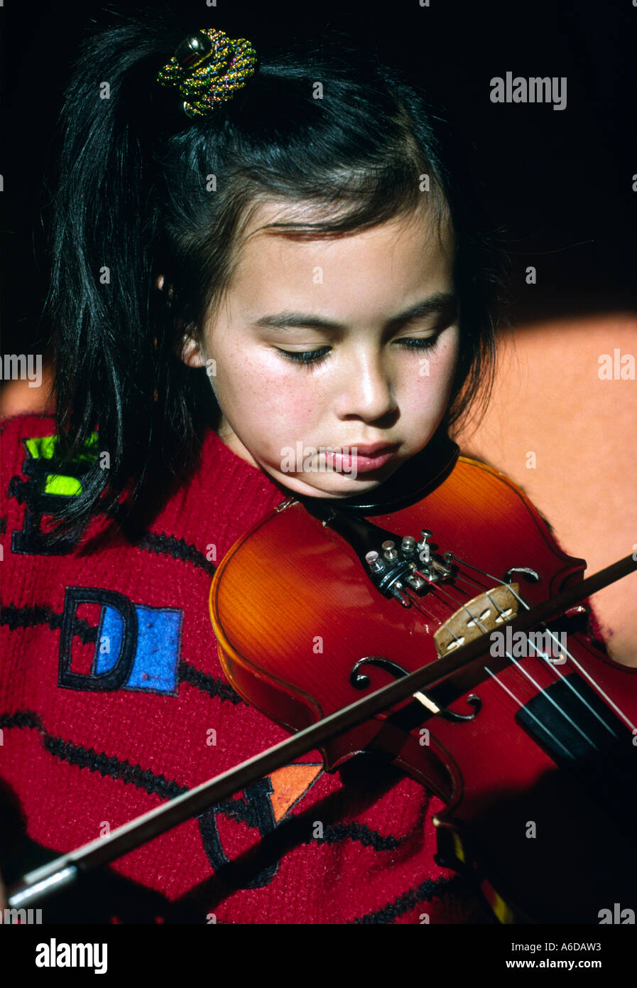 nine 9 year old girl plays violin Stock Photo