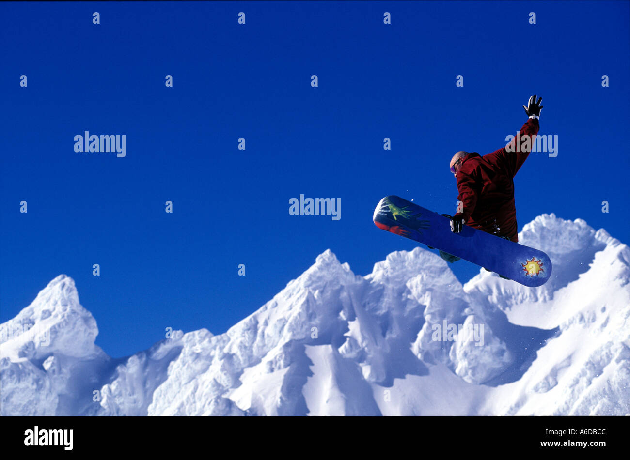 Snowboard jump with scenic alpine backdrop Stock Photo Alamy