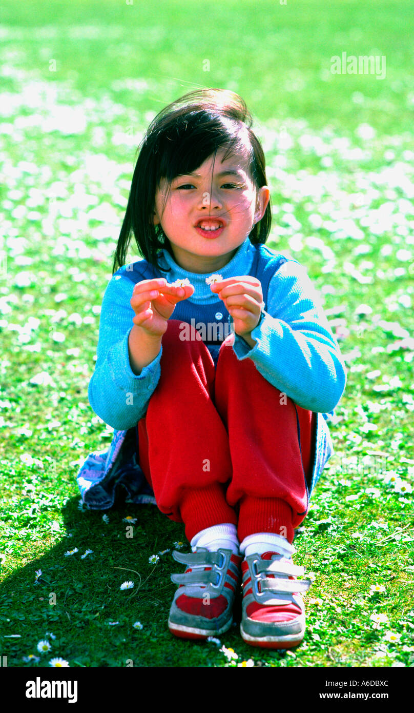 5436 girl holds small white flowers Stock Photo