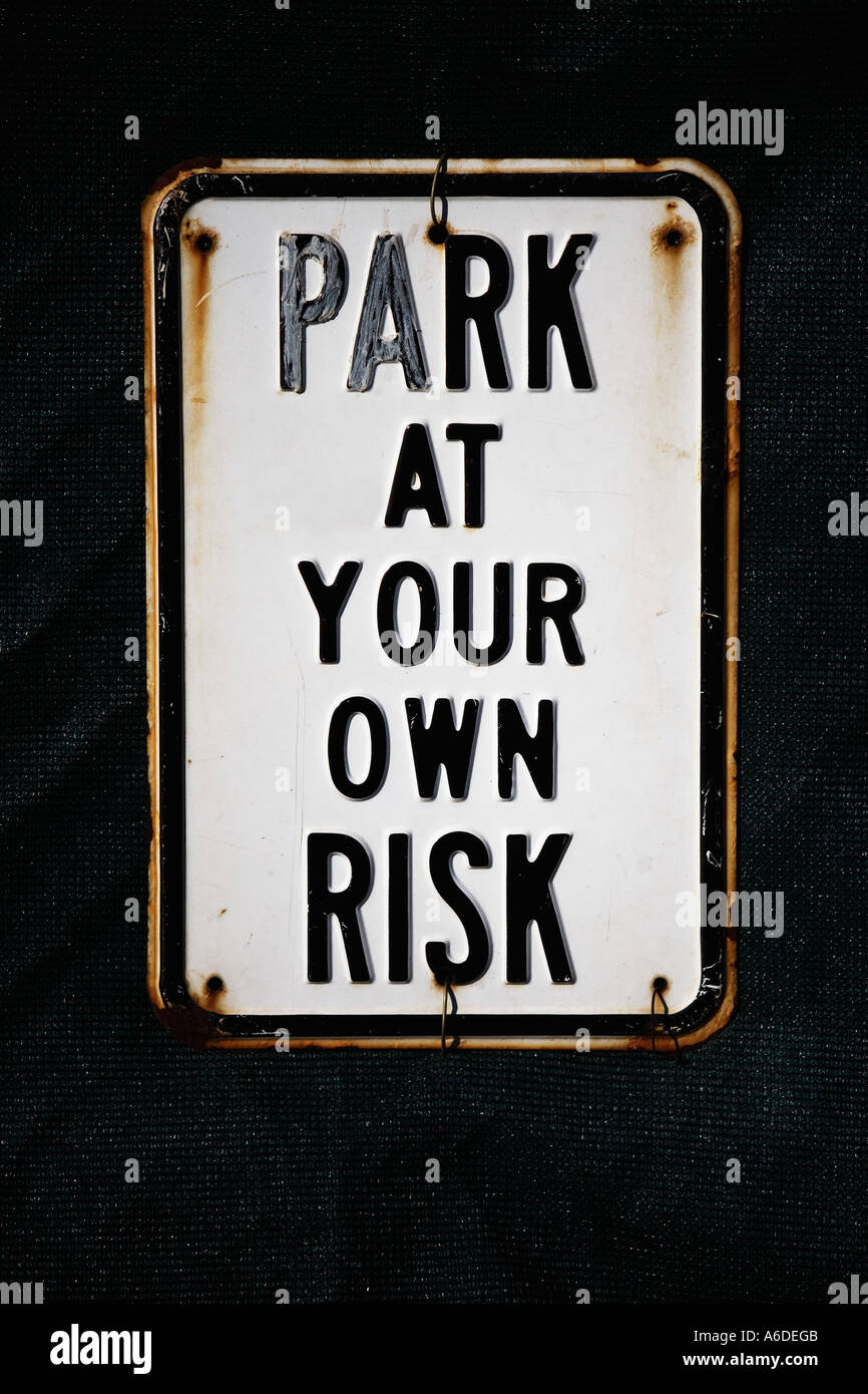 PARK AT YOUR OWN RISK SIGN Stock Photo - Alamy