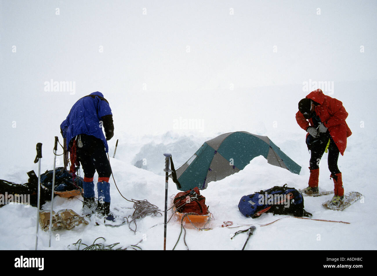 alaska denali national park climbers prepare to depart camp during a whiteout snowstorm on the Kahiltna glacier Stock Photo