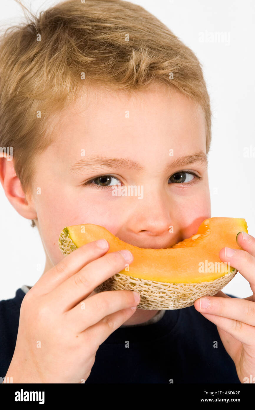 Boy eating melon,portrait Stock Photo Alamy