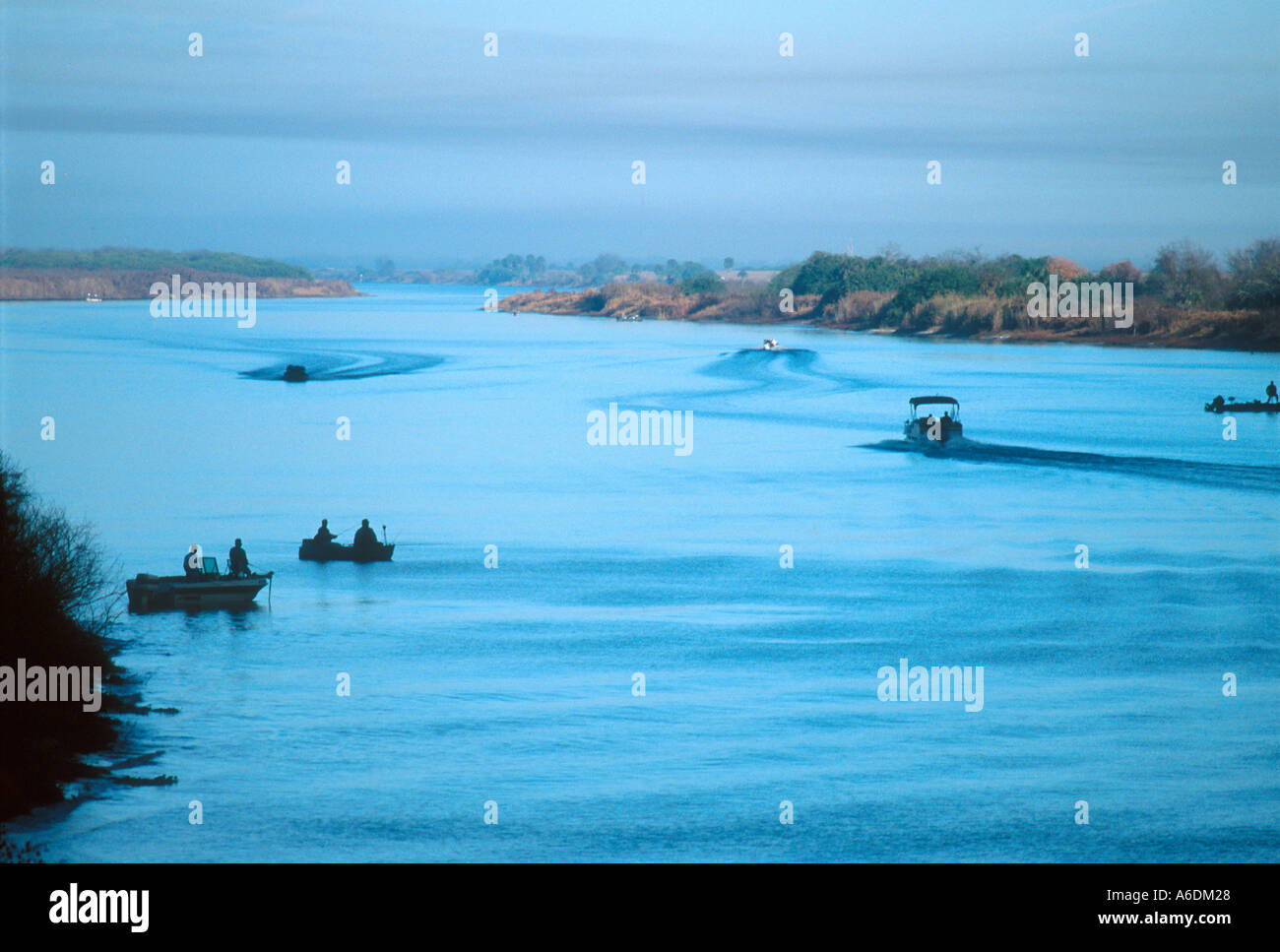 Boats with fishermen on the Kissimmee River near the mouth to Lake