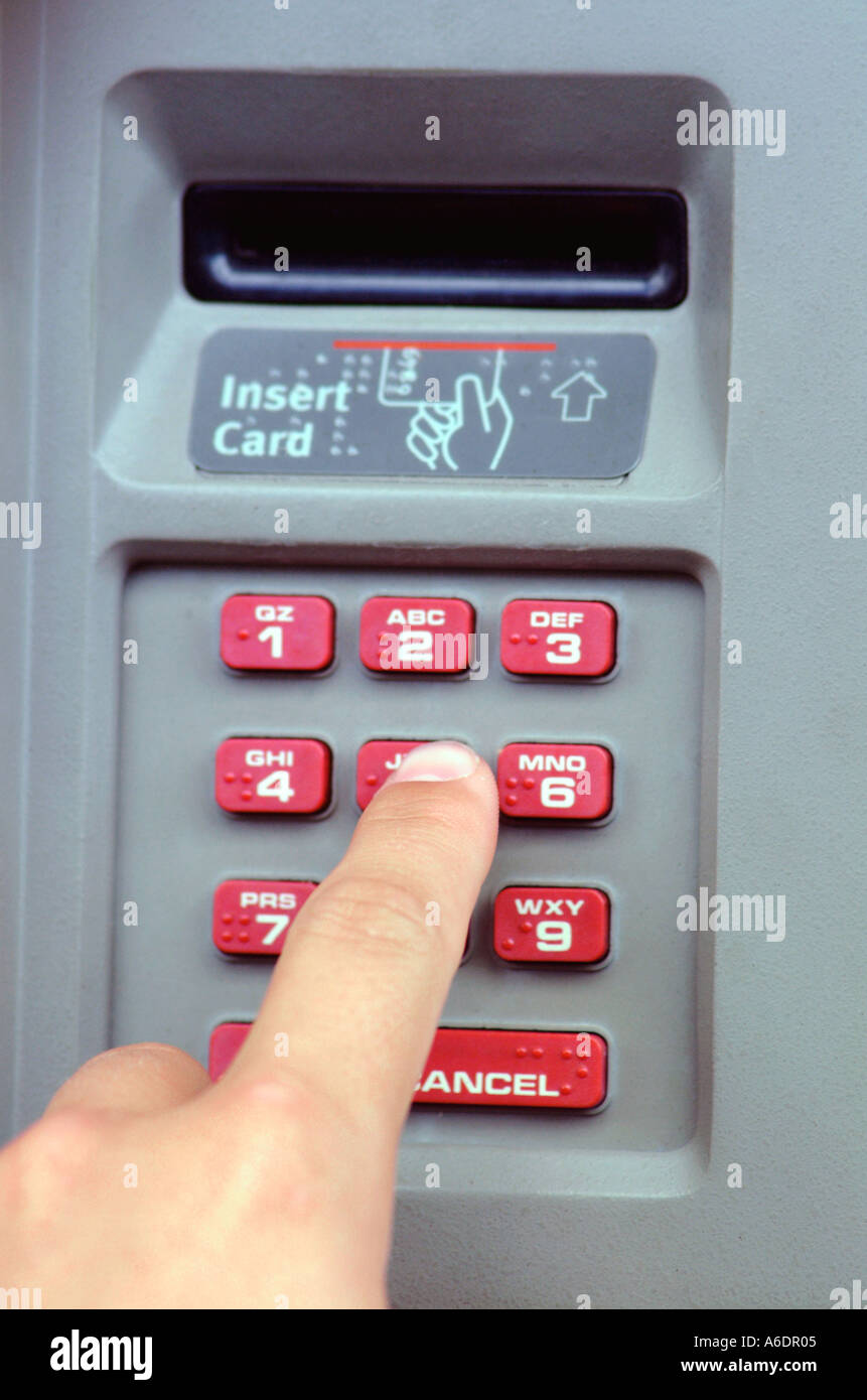 atm machine card insert slot and kepad with finger of user atm machine