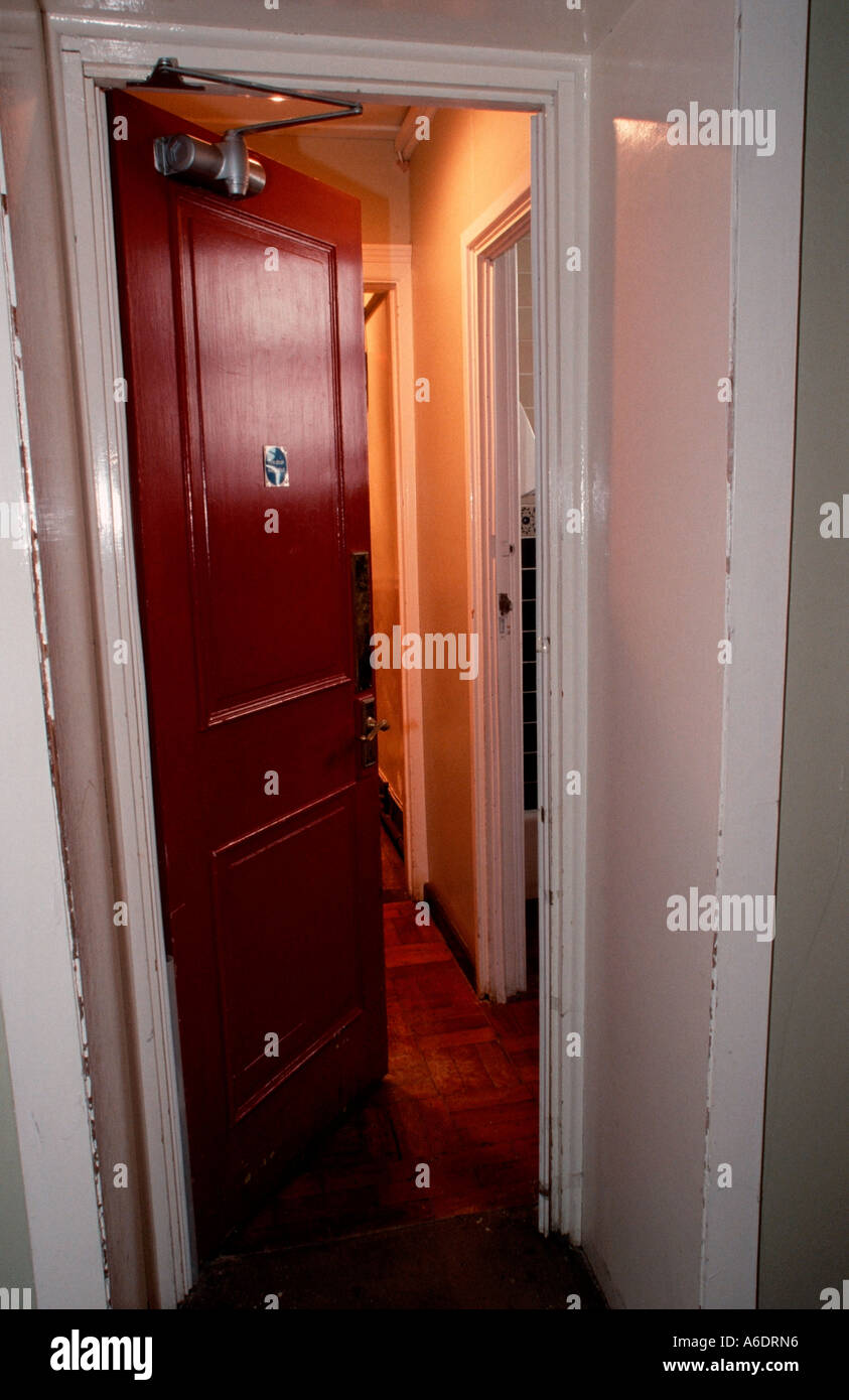 Half open red wooden fire door Stock Photo