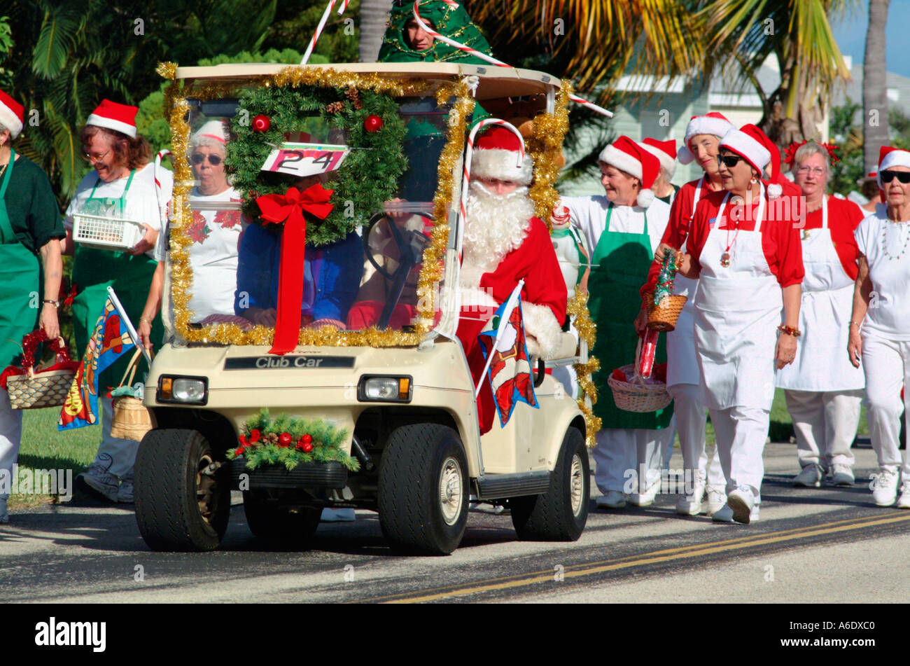 Senior Citizens Marching With Santa Clause In A Decorated Golf